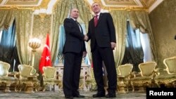 Russian President Vladimir Putin, left, shakes hands with Turkey's President Recep Tayyip Erdogan during their meeting in the Kremlin in Moscow, March 10, 2017.